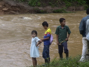 Children standing by a rushing river in Nicaragua