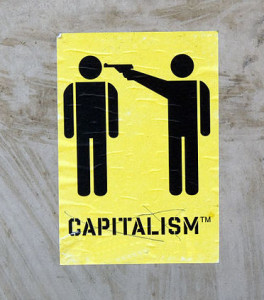 https://commons.wikimedia.org/wiki/File:Capitalism_graffiti_luebeck.jpg stick figures of one person with a gun to another's head, labeled capitalism