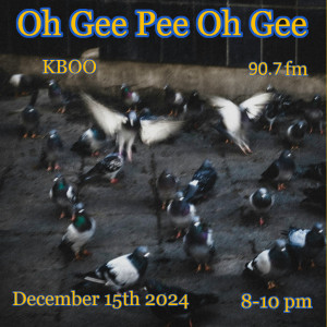 Amid a dark image of pigeons gathered on the ground a blue of white wings as two take off