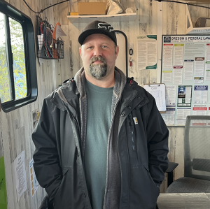 Elijah - man standing in office pod at Menlo Park Safe Rest Village