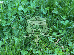 A very green field of clover with the Self Help Radio logo overlayed on it.
