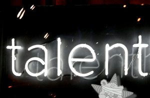It is an image of the word "talent" in bright white neon with a similarly lit-up Self Help Radio logo in the corner of the image.