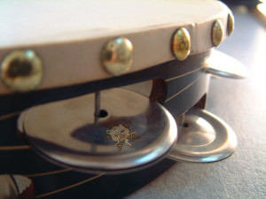 A close up image of the tambourine with the Self Help Radio logo on it