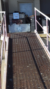 An industrial scene with a sign that says "Waste Time" under which is the Self Help Radio log