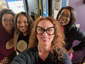 four women smiling